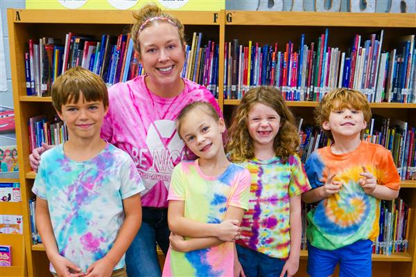 students and teacher in the library